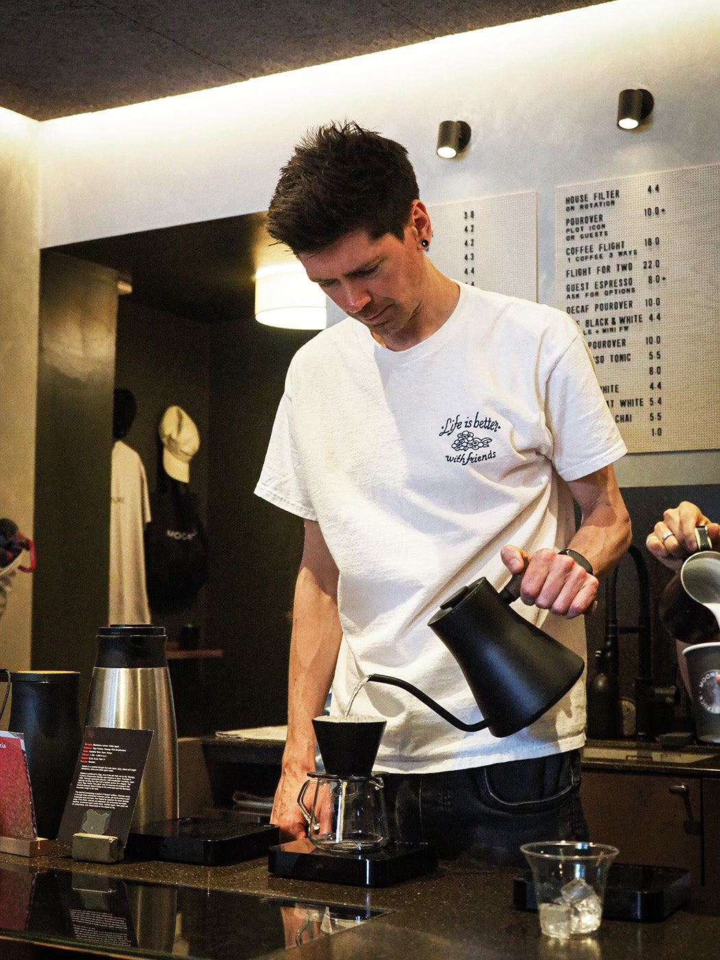 The owner of Moonstruck Cafe Liam Clifford is in the cafe behind the bar making a pourover filter coffee